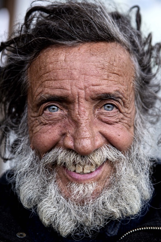 Portrait of an elderly man with a white beard, close crop