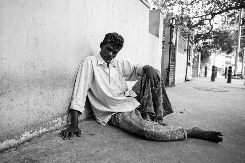 A man resting on the street, Chennai, India